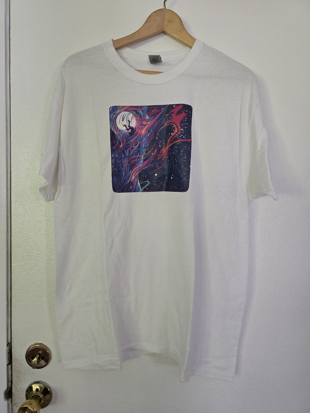 white t-shirt features a graphic titled "Fly Man on the Moon"
